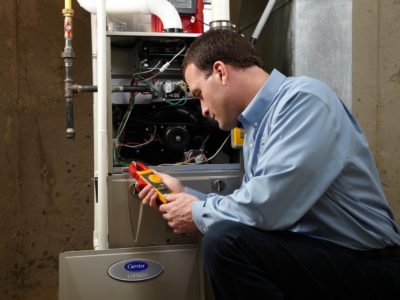 Heating technician servicing a furnace