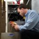 Heating technician servicing a furnace