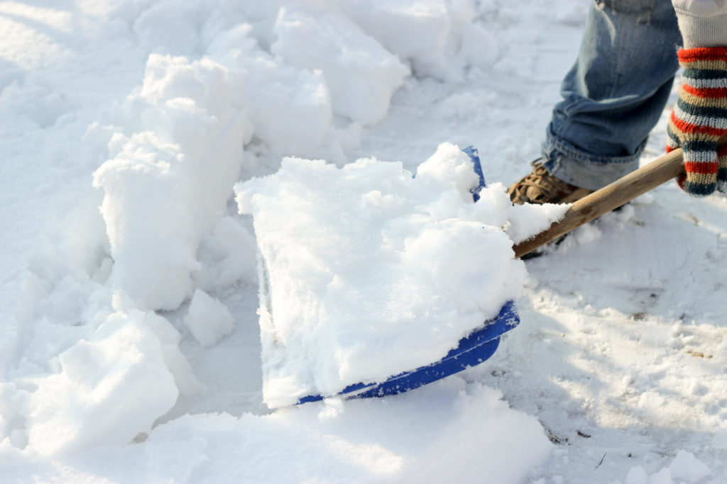 Snow shoveling, sunny winter day