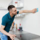 Man cleaning kitchen walls