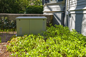 Residential backup generator outside a house