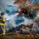 Firefighter at house with hose