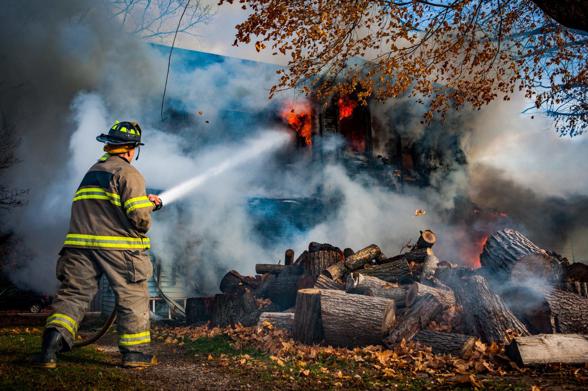 Firefighter at house with hose