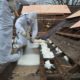 Spray foam is applied to the flat roof section from the outside.