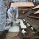 Spray foam is applied to the flat roof section from the outside.