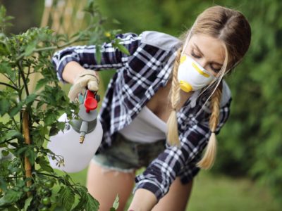 Woman spraying pesticide