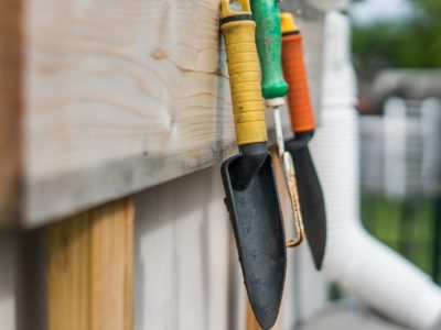 Garden tools hung up in a shed