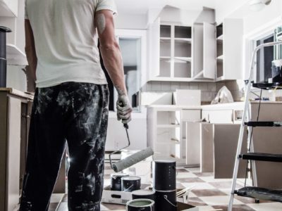 Man painting a white kitchen