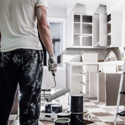 Man painting a white kitchen