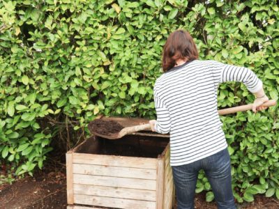 Woman creating compost for a garden