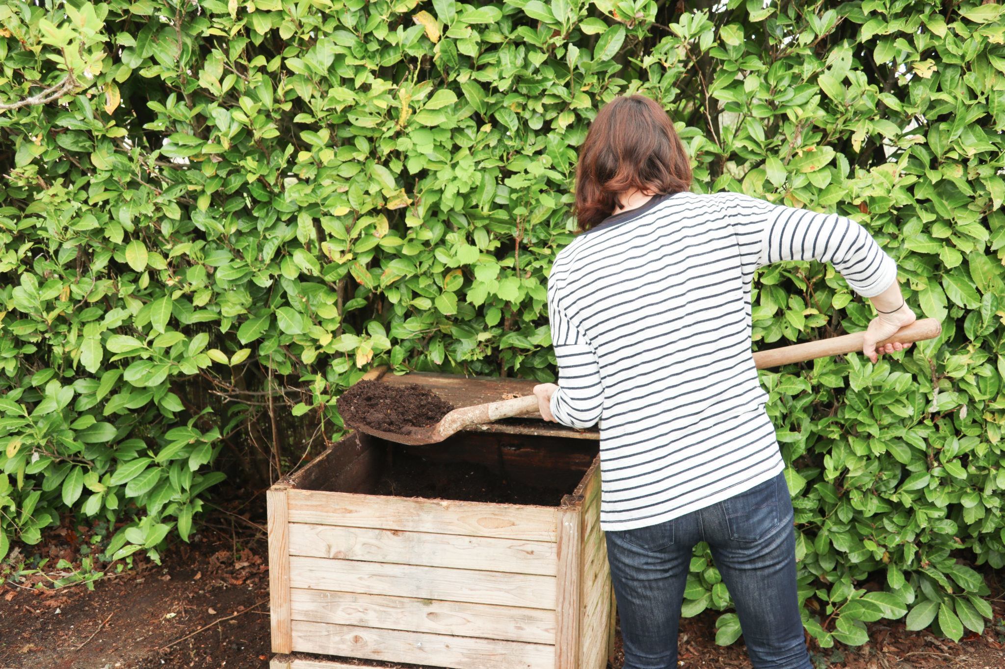Woman creating compost for a garden