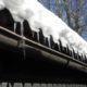 Ice dams on an old roof over a gutter