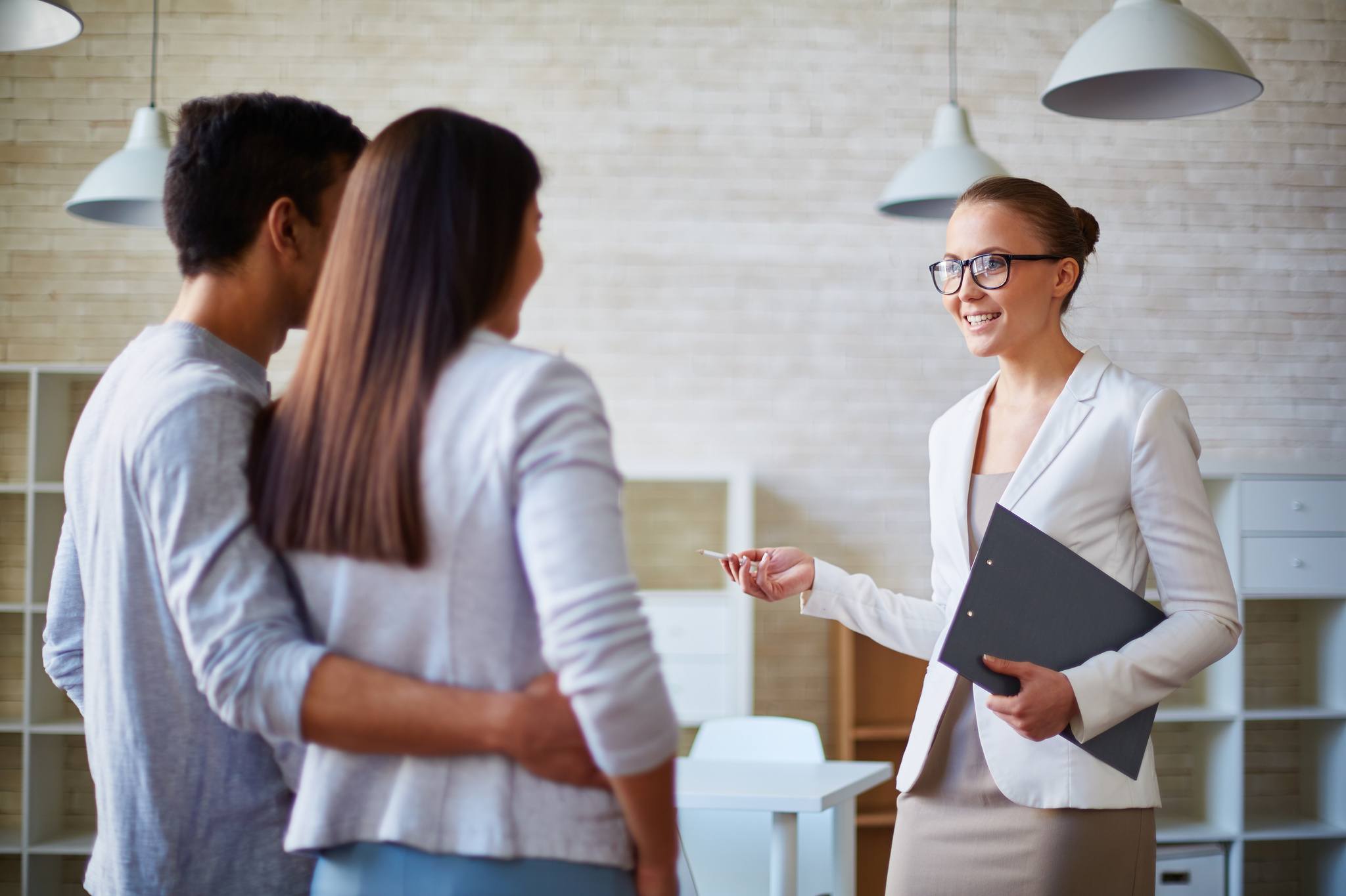 Couple looking at a home with a real estate agent