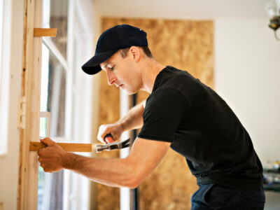 Man adjusting a sliding glass patio door.