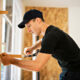 Man adjusting a sliding glass patio door.