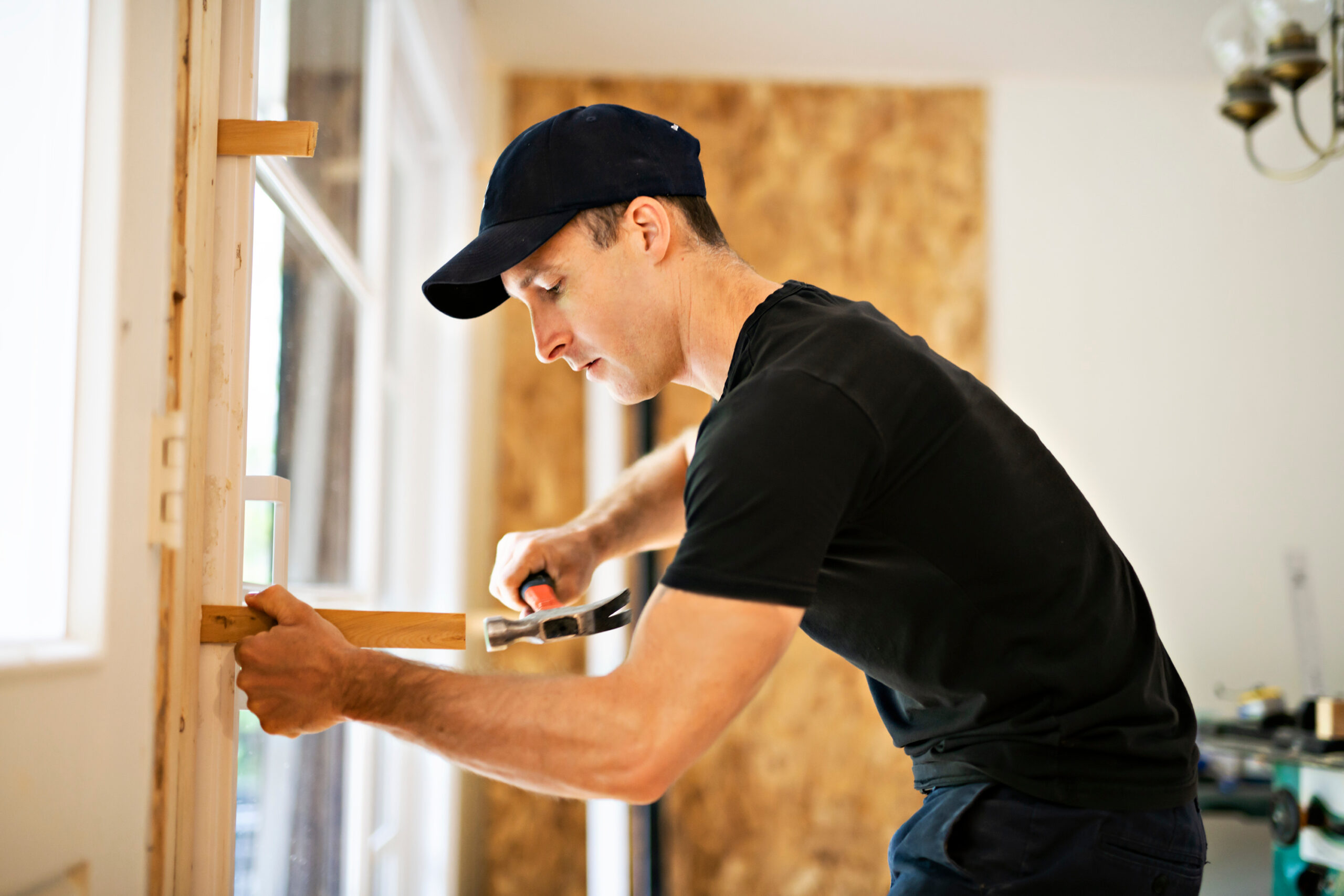 Man adjusting a sliding glass patio door.