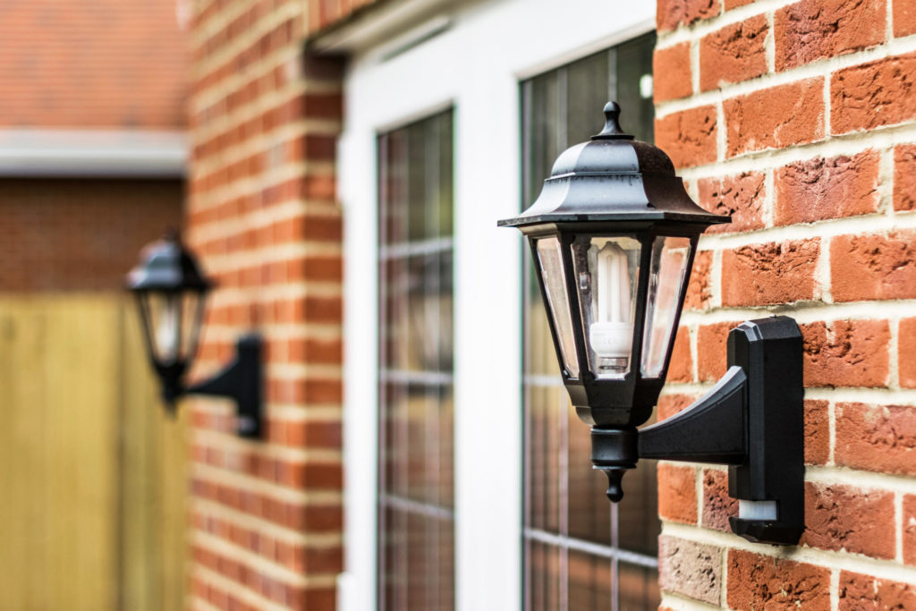 Exterior light near front door with a CFL light bulb