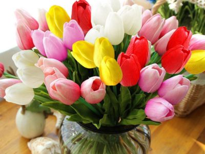 Artificial tulips in a vase on a table