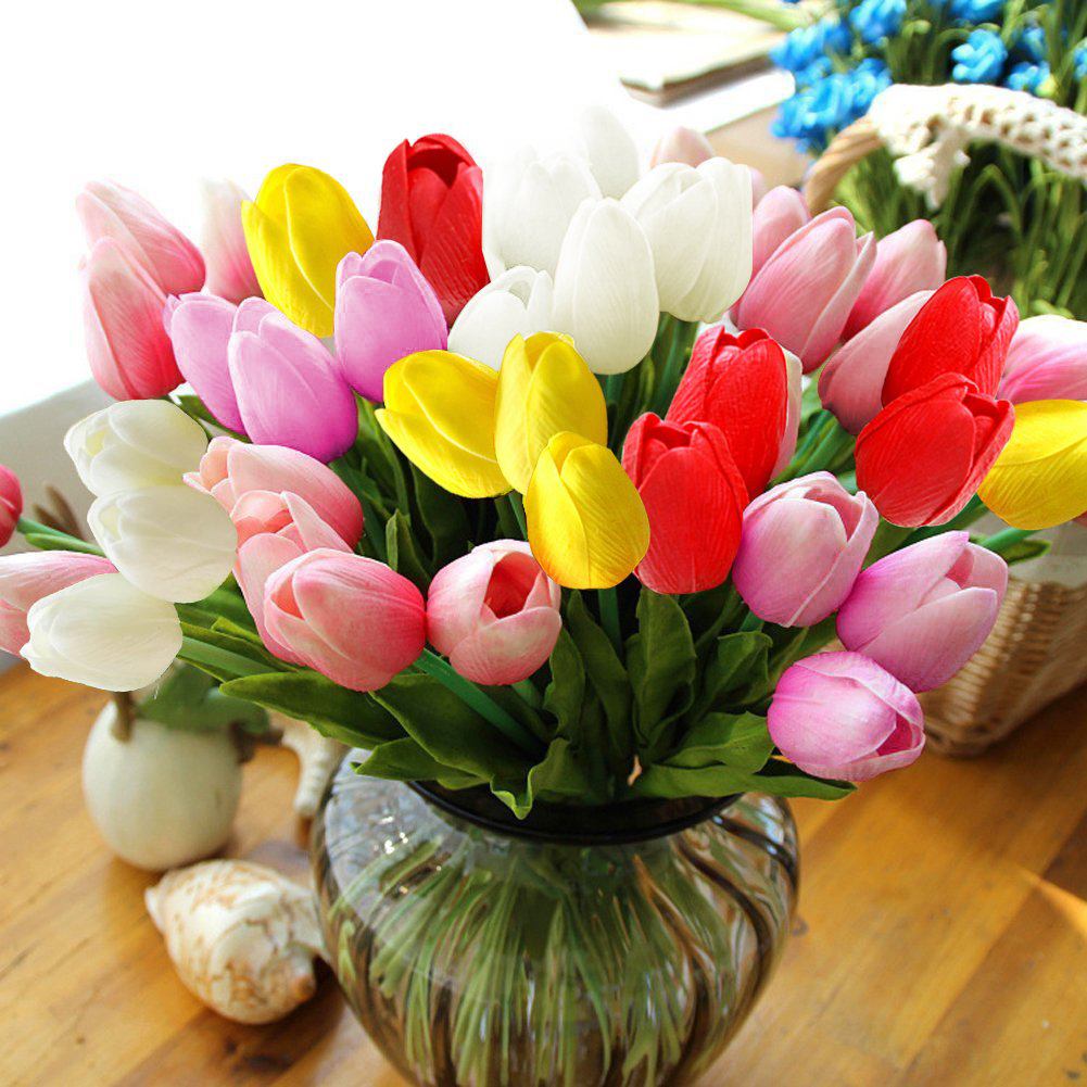 Artificial tulips in a vase on a table