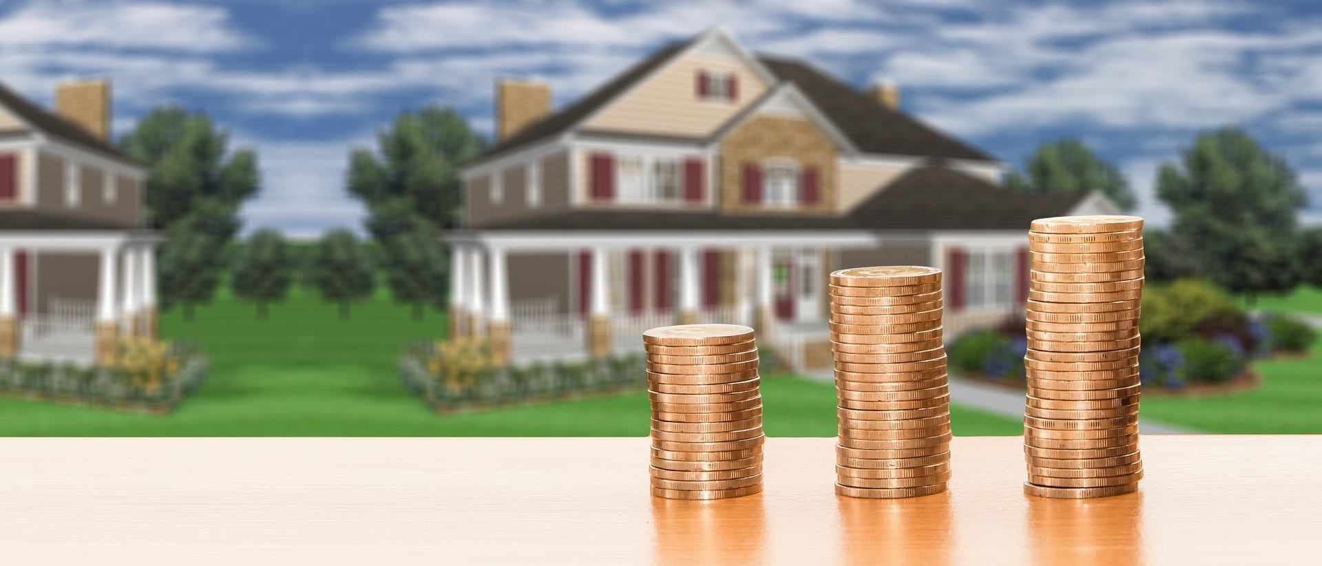 Money in front of a newly purchased home