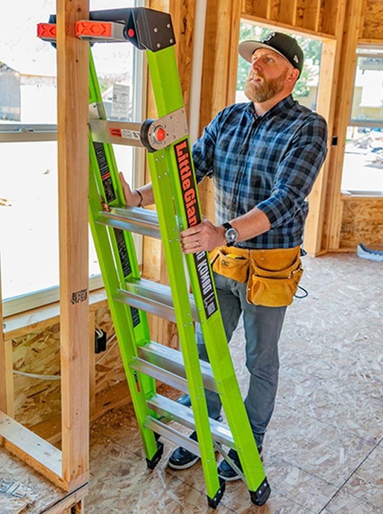 Contractor using Little Giant King Kombo ladder on a stud wall.