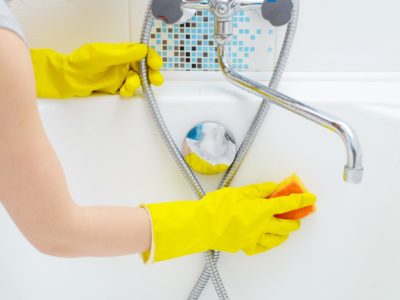 A woman cleaning bath at home