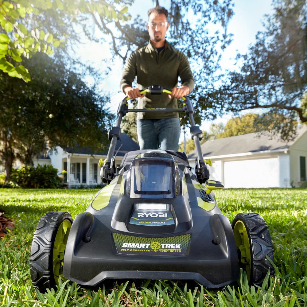 Man walking behind cordless lawn mower