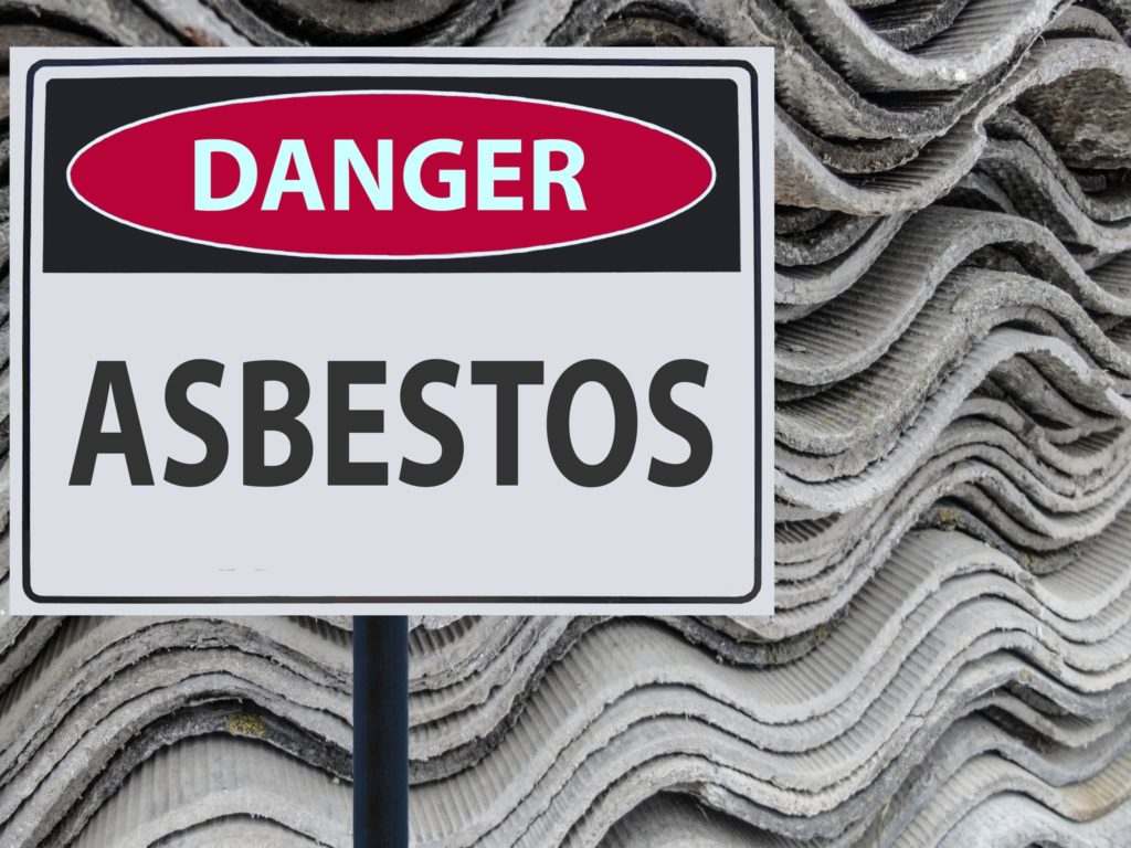 Asbestos danger sign. Buying a home with asbestos insulation or siding can be costly to correct.
