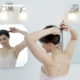 Bright bathroom with woman looking in mirror