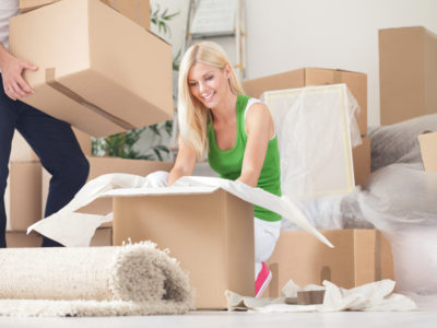 Man and woman packing boxes to move