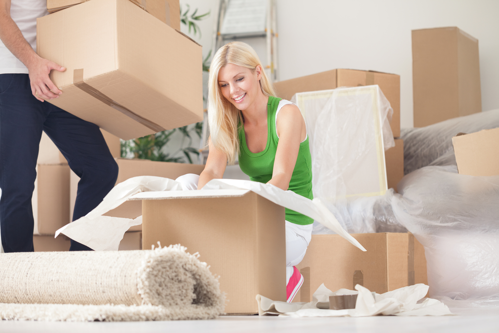 Man and woman packing boxes to move