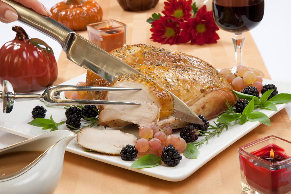 Turkey being carved on a beautiful table