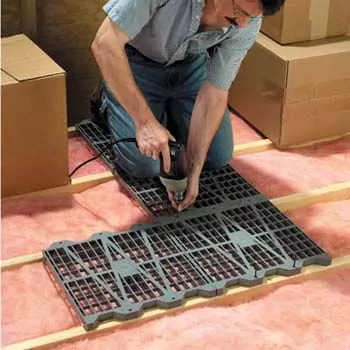 Woman installing AtticDek floor storage panels