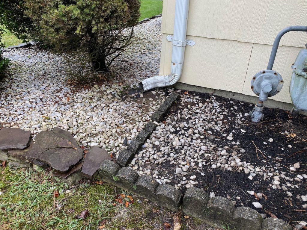 Gutter downspout draining too close to house