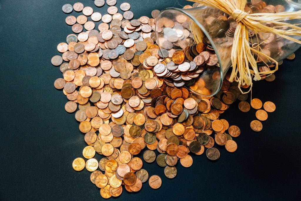 Pennies spilling out of glass vase