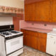 Old kitchen with pink backsplash and wallpaper border