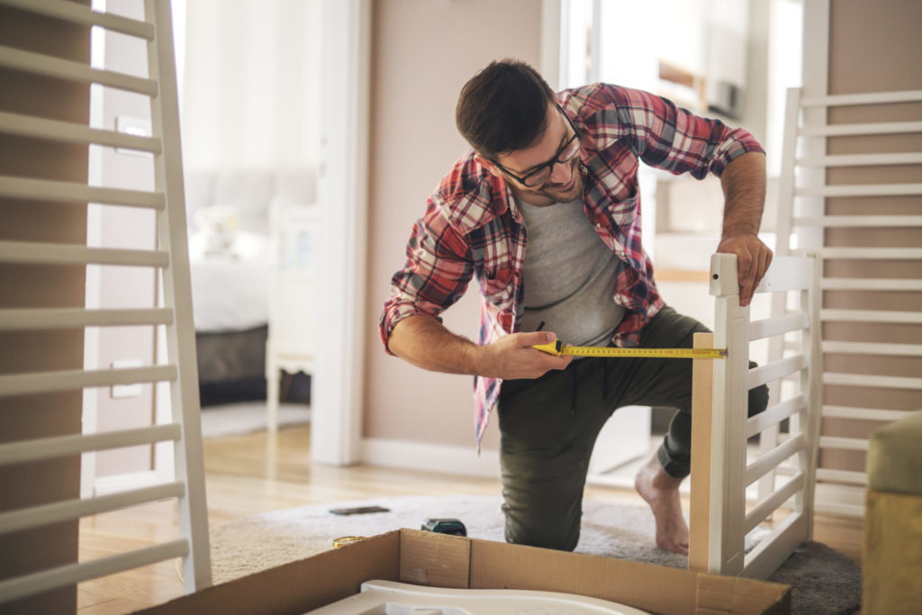 Assembling a wooden crib for baby