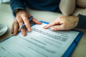 Close up of signing a mortgage contract