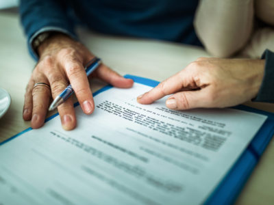 Close up of signing a mortgage contract