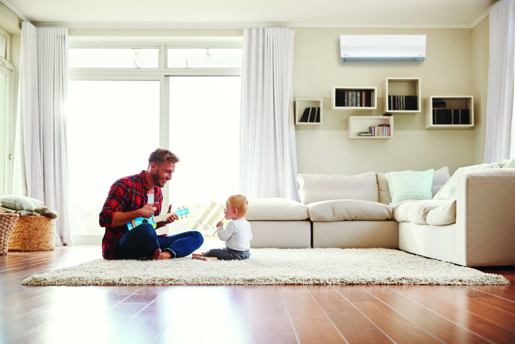 Father playing with young son in air conditioned room