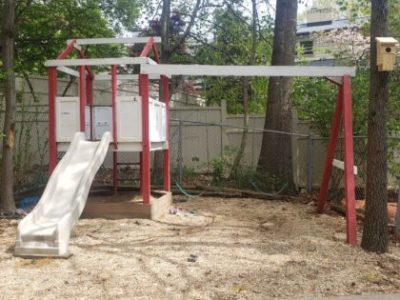 Plastic swing set on sandy soil