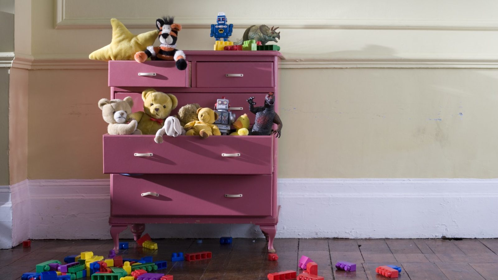 Toys overflow a dresser