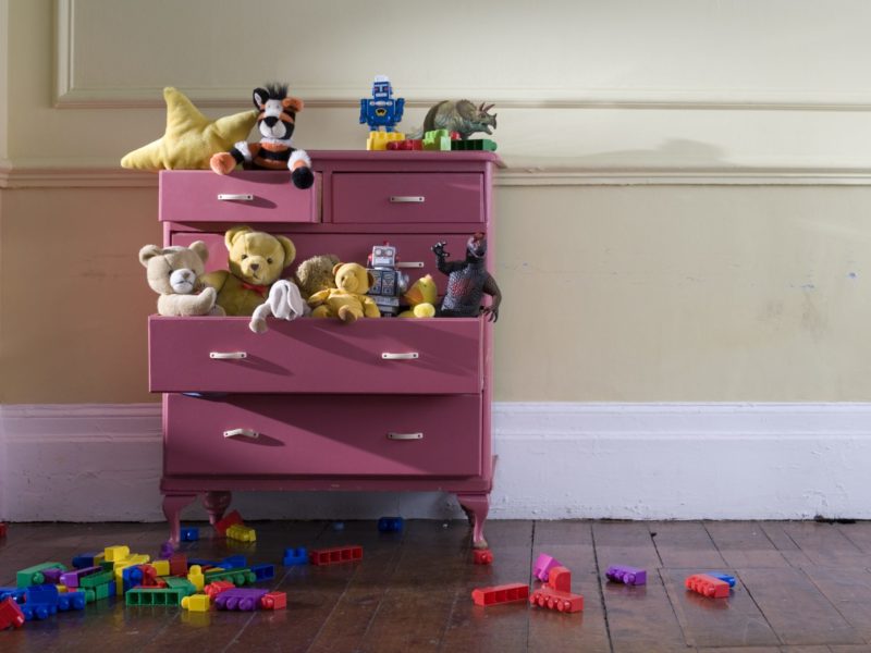 Toys overflow a dresser