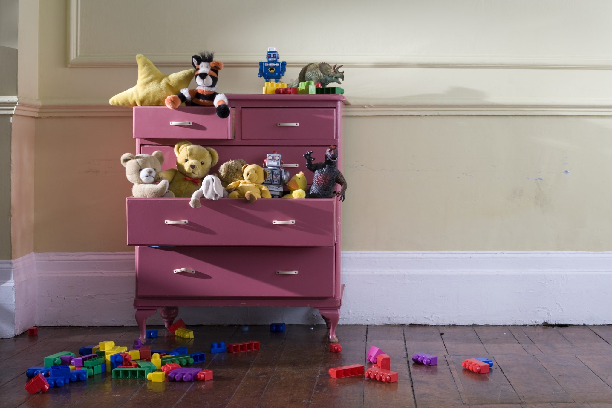 Toys overflow a dresser