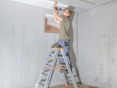 Man installing basement ceiling.