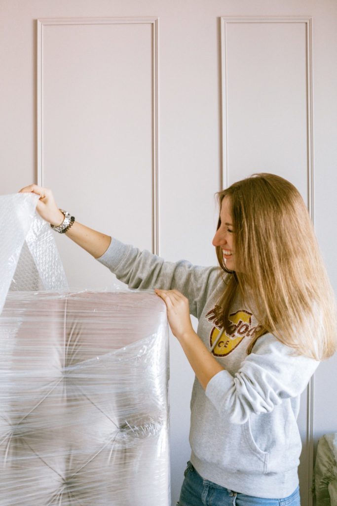 Woman unwrapping new furniture.