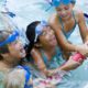 3 children playing in swimming pool