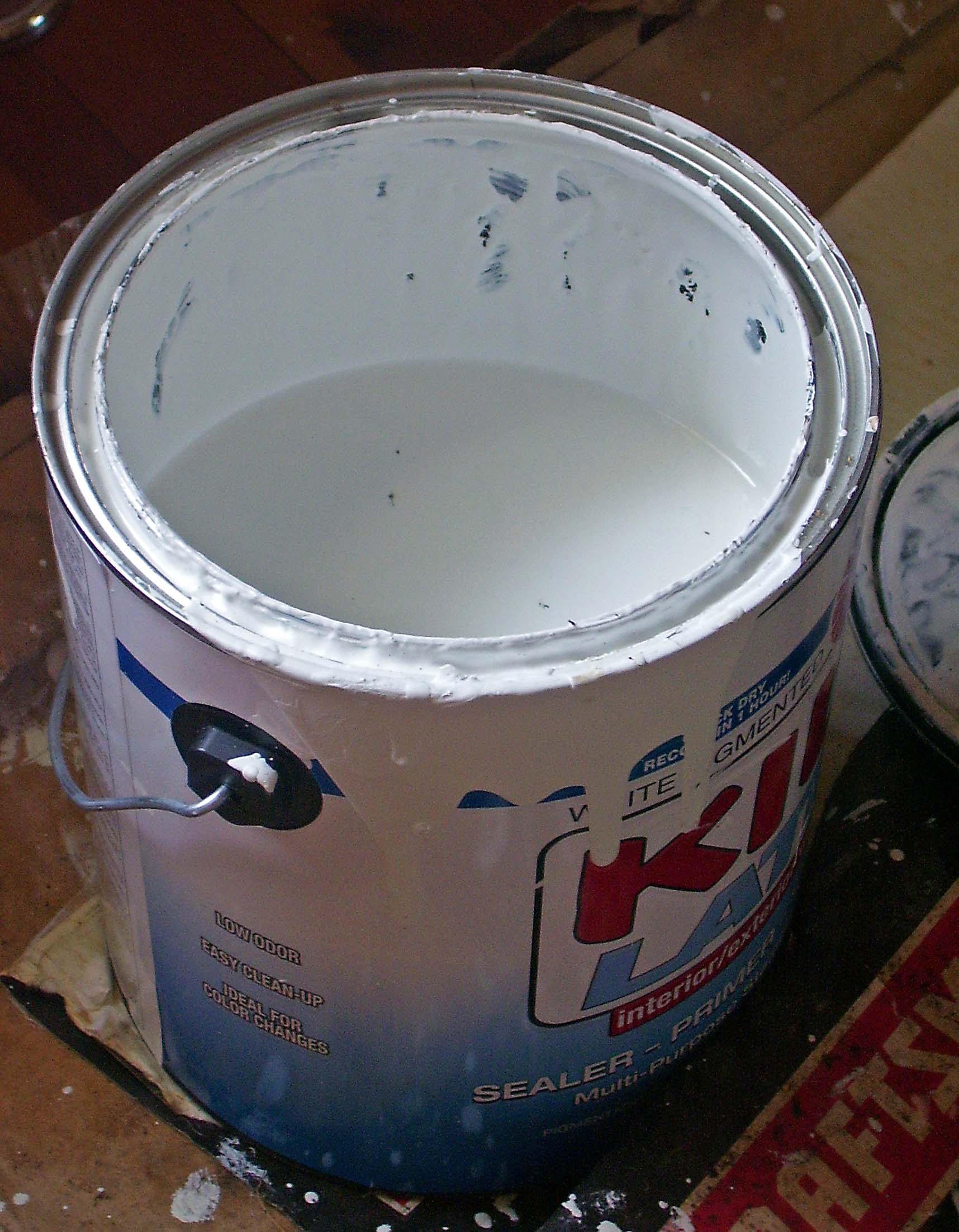 Half empty can of white paint