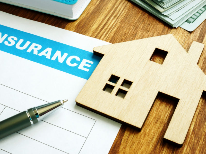House insurance form for homeowners and model of home.