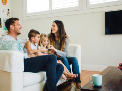 Family sitting in a new remodeled basement